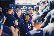  ?? New York Yankees/Getty Images ?? The Yankees’ Willie Calhoun high fives teammates after hitting a home run during a spring training game against the Rays at George M. Steinbrenn­er Field on March 4 in Tampa, Fla.