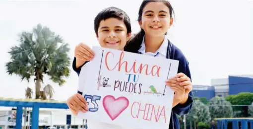  ?? by Alexander Pena/xinhua ?? February 7, 2020: 11-year-old Javier and his 13-year-old sister show their support and blessing for China with their painting in San Salvador, the capital of El Salvador.