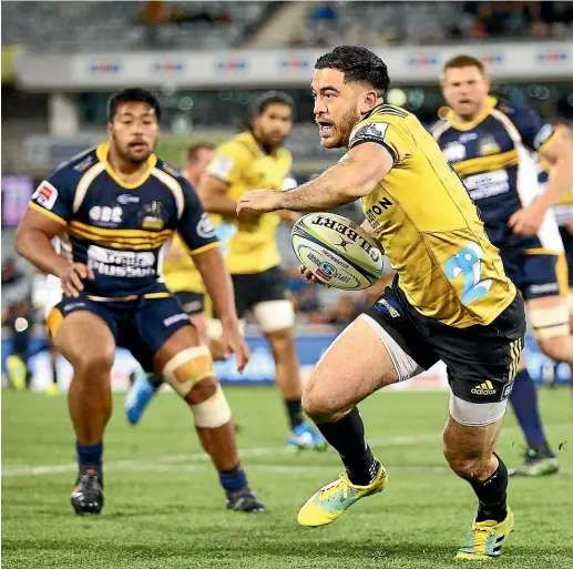  ?? GETTY IMAGES ?? Nehe Milner-skudder playing for the Hurricanes takes on the Brumbies defence during a Super Rugby match.