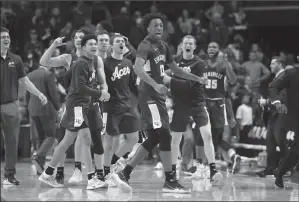  ?? TRIBUNE NEWS SERVICE ?? Deandre Williams (13) of the Evansville Aces celebrates in the 67-64 win over the Kentucky Wildcats at Rupp Arena on Tuesday in Lexington, Kentucky.