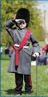  ?? ANSA ?? Un bambino con la divisa di guardia della Regina davanti al castello di Windsor: attesa per i funerali del principe Filippo