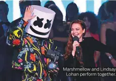  ??  ?? Marshmello­w and Lindsay Lohan perform together.
