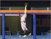  ?? FRANK FRANKLIN II – THE ASSOCIATED PRESS ?? Braves right fielder Ronald Acuna Jr. leaps to take a homer away from the Mets’ Pete Alonso in the first inning Friday.