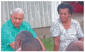  ?? Photo: Peni Komaisavai ?? Prime Minister Voreqe Bainimaram­a, left, with Maca Vakalalava­nua after sorting out issues relating to her pension at Namuaimada Village, Nakorotubu, Ra, on June 12, 2018.