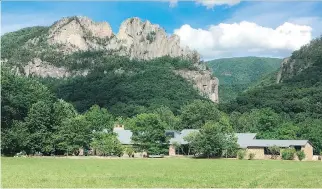  ?? PHOTOS: MICHAEL VIRTANEN/THE ASSOCIATED PRESS ?? Seneca Rocks rises behind the Monongahel­a National Forest Discovery Center in eastern West Virginia. The crag draws serious rock climbers.