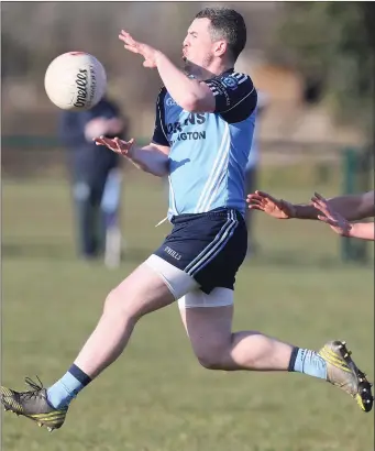  ??  ?? Ciaran Kelly takes to the air to grab possession for St Colmcille’s against Skryne.