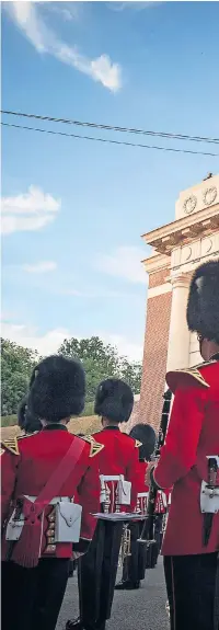  ??  ?? A Guardsmen band at the Menin Gate. Theresa May, the Prime Minister, below, attended the ceremony in Ypres