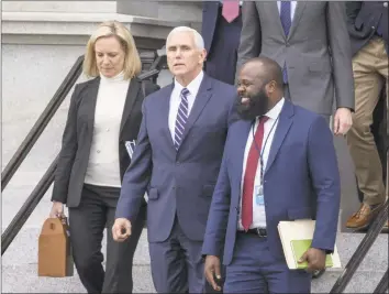  ?? Tasos Katopodis / Getty Images ?? Secretary of Homeland Security Kirstjen Nielsen, Vice President Mike Pence and Ja’Ron Smith special assistant to the president of the United States, exit the Eisenhower Executive Office Building on Saturday. The U. S government is going into the third week of a partial shutdown with Republican­s and Democrats at odds on agreeing with President Donald Trump’s demands for more money to build a wall along the U. S.- Mexico border.