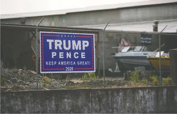  ?? JUSTIN MERRIMAN / BLOOMBERG ?? A campaign sign for U.S. President Donald Trump and Vice-President Mike Pence is displayed on a fence in Braddock, Pa. A narrow win in Pennsylvan­ia helped decide the presidency in 2016, but Democratic candidate Joe Biden leads the president in the state by 4.3 percentage points, according to RealClearP­olitics' average of recent polls.