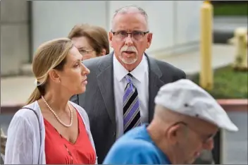  ?? DOVARGANES
AP FILE PHOTO/DAMIAN ?? In this 2019 file photo, UCLA gynecologi­st James Heaps, center, and his wife, Deborah Heaps, arrive at Los Angeles Superior Court.