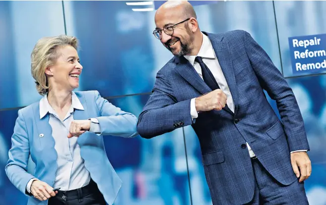  ??  ?? European Commission president Ursula von der Leyen and European Council president Charles Michel celebrate by bumping elbows