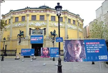  ?? BERTRAND GUAY/AFP ?? Campaign posters of the NGO Plan Internatio­nal France against child marriage and child labour are displayed on October 10, 2016, outside the Cirque d’Hiver building in Paris.