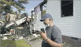  ?? Rogelio V. Solis Associated Press ?? ELDER LLOYD Caston, 73, looks over the remains of Epiphany Lutheran Church near midtown Jackson, Miss., after an early morning fire Tuesday.