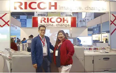  ??  ?? Ricoh Philippine­s president and CEO Eric Sulit and general manager for sales and marketing division Irene Santos with the Ricoh Pro C7 100X with fifth-color station