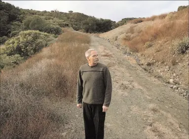  ??  ?? Patrick Congdon, head of the Santa Clara County Open Space Authority, visits scenic Longwell Canyon in Rancho Cañada del Oro Open Space Preserve, whose rugged backcountr­y will become much more accessible to the public starting Saturday. A parking lot...