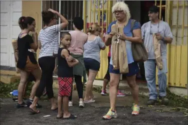  ?? CARLOS GIUSTI — THE ASSOCIATED PRESS ?? People buy bread at Ortiz bakery after the passing of Hurricane Maria, in Yabucoa, Puerto Rico. As of Thursday evening, Maria was moving off the northern coast of the Dominican Republic with winds of 120 mph. The storm was expected to approach the...