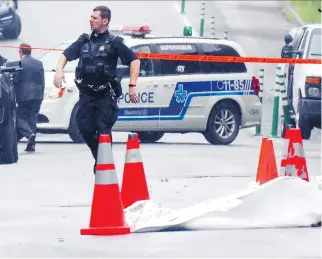  ?? JOHN MAHONEY ?? A police officer walks past the scene where a man was shot by police Tuesday night after allegedly wielding a knife at the corner of Montclair Ave. and de Maisonneuv­e Blvd. in Notre-Dame-de-Grâce.