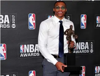  ??  ?? OKLAHOMA CITY THUNDER player Russell Westbrook poses for photos with his 2017 NBA most valuable player award during the 2017 NBA Awards at Basketball City at Pier 36.