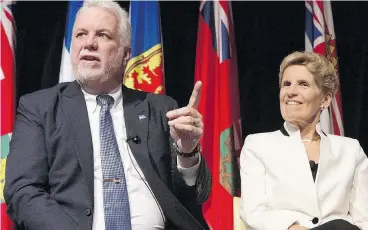  ?? CHRIS YOUNG / THE CANADIAN PRESS FILES ?? Quebec Premier Philippe Couillard and Ontario Premier Kathleen Wynne head provincial government­s going in opposite financial directions, Kelly McParland writes.