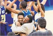  ?? GENE J. PUSKAR/ASSOCIATED PRESS ?? Coppin State coach Ron “Fang” Mitchell, right, hugs Antoine Brockingto­n after they upset South Carolina in 1997.