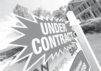  ?? Associated Press Associated Press ?? ABOVE: A sign advertises that an existing home for sale is under contract on May 16 in Roswell, Ga. Saving up for a down payment is the biggest hurdle for many would-be homebuyers, particular­ly those looking to make the leap from renting to owning.