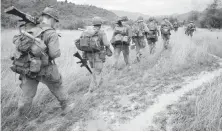  ??  ?? Soldiers are on patrol in this scene from Ken Burns’ documentar­y, The Vietnam War. The series premières Sept. 17 on PBS.