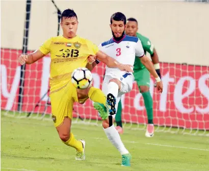  ?? Supplied photo ?? Al Wasl’s Fabio de Lima (yellow) is tackled by a Sharjah player during their AGL match on Saturday night. —