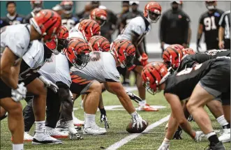  ?? JOHN MINCHILLO / ASSOCIATED PRESS ?? Cincinnati Bengals center Billy Price (center) lines up a play during practice at the team’s practice facility, on June 12. The Bengals have some offensive line questions to answer.