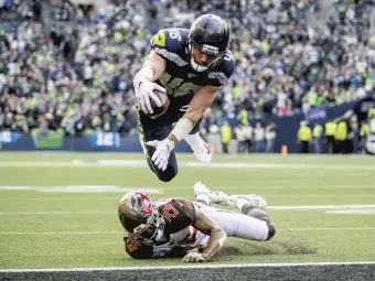  ?? MIKE SIEGEL/TNS ?? Seattle tight end Jacob Hollister dives over Tampa Bay defensive back Sean Murphy-Bunting and the goal line for his first career score, a 1-yard touchdown in the second quarter Sunday in Seattle.