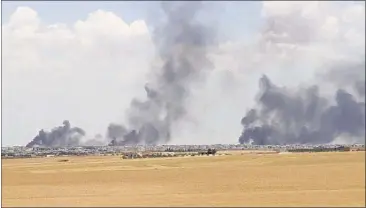  ?? ARAB 24 VIA ASSOCIATED PRESS ?? This video grab shows smoke rising from the city of Manbij, Syria. U.S.-backed fighters on Thursday closed all major roads leading to the northern Syrian town of Manbij, a stronghold of the Islamic State group, and surrounded it from three sides,...