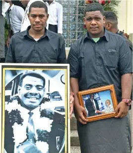  ?? Photo: Mereleki Nai ?? The late Ratu Sela Toga’s grandsons, Marika Toga and Simeli Vaciloa hold photos of their late grandfathe­r in front of the Saunaka Church, Nadi on December 30, 2021.