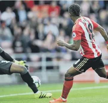  ??  ?? Sunderland striker Jermain Defoe slides home his opening goal in Saturday’s Premier League clash with Crystal Palace