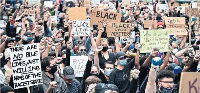  ?? JOHANNES EISELE AFP VIA GETTY IMAGES ?? Anti-racism protests have led to curfews in several U.S. cities this week to suppress rioting following the death of George Floyd while in police custody. Canadians rallied in support at weekend marches in Toronto and Montreal.