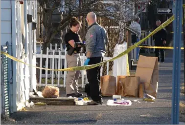  ?? PHOTO BY JOHN BECHTOLD ?? Investigat­ors work at the scene of the fatal shooting in Midtown Kingston, N.Y., on Sunday, March 21.