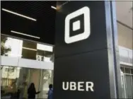  ?? AP PHOTO/ERIC RISBERG ?? People make their way into the building that houses the headquarte­rs of Uber on Wednesday in San Francisco. CEO Travis Kalanick is out as chief executive, resigning under pressure amid a federal investigat­ion and claims of widespread sexual harassment...