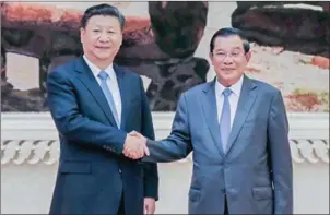  ?? HONG MENEA ?? Xi Jinping, president of China and the Communist Party, and Prime Minister Hun Sen shake hands in October 2016.