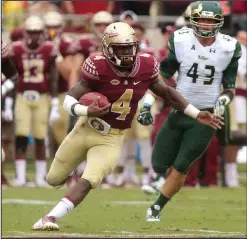  ??  ?? Florida State’s Dalvin Cook, center, scampers 74 yards for a touchdown against South Florida.