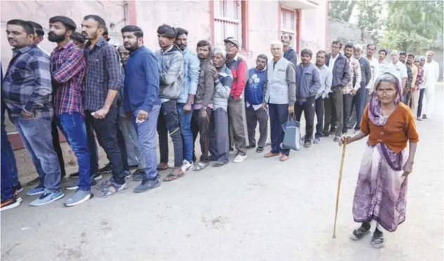  ?? Associated Press ?? ↑
An elderly woman arrives to cast her vote during the first phase of Gujarat elections in Limbdi on Thursday.