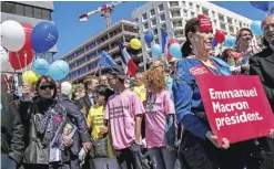  ?? — AFP ?? LYON: Supporters of French presidenti­al candidate for the En Marche! movement Emmanuel Macron gather in Lyon yesterday ahead of the second and final round of the presidenti­al election on May 7.