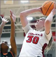  ?? (NWA Democrat-Gazette/Charlie Kaijo) ?? Farmington center Kaycee McCumber (30) shoots over the Nashville defense Saturday at Farmington’s Cardinal Arena. McCumber scored 12 points in the Lady Cardinals’ 69-35 victory. The win moved Farmington into the Class 4A championsh­ip game against Morrilton on Thursday at Bank OZK Arena in Hot Springs.