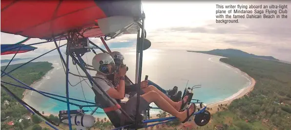  ??  ?? This writer flying aboard an ultra-light plane of Mindanao Saga Flying Club with the famed Dahican Beach in the background.