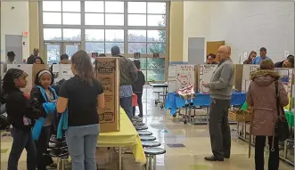  ??  ?? Students, staff and parents browse the STEM-based inventions during the Invention Convention.