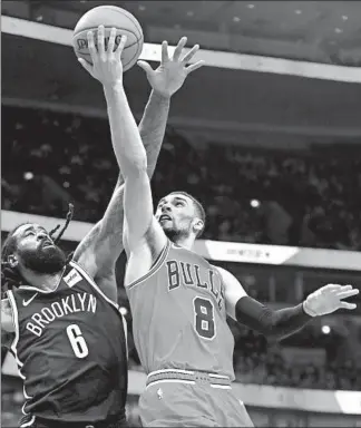  ?? CHRIS SWEDA/CHICAGO TRIBUNE ?? Zach LaVine (8) drives to the hoop against Nets center DeAndre Jordan in the second half of the Bulls’ loss.