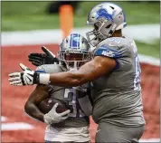  ?? DANNY KARNIK — THE ASSOCIATED PRESS ?? Detroit Lions offensive tackle Tyrell Crosby (65) and running back D’Andre Swift (32) celebrate a touchdown against the Atlanta Falcons last Sunday in Atlanta. The Detroit Lions won 23-22. The Lions are looking to win its third straight game Sunday against the Indianapol­is Colts. A productive running attack led by Swift is a key to victory.