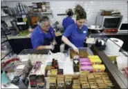  ?? LYNNE SLADKY — ASSOCIATED PRESS ?? Emma Gonzalez, left, and Lidices Ramos, right, make empanadas at the Mendez Fuel convenienc­e store in Miami last month.