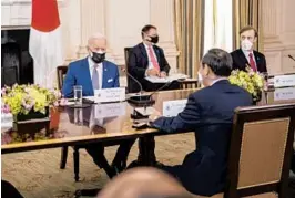  ?? DOUG MILLS/THE NEW YORK TIMES ?? Hosting a foreign leader for the first time as president, Joe Biden sits opposite Prime Minister Yoshihide Suga of Japan on Friday at the White House.
