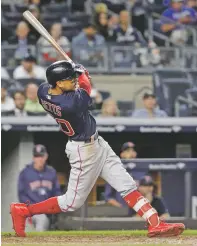  ?? JULIO CORTEZ/ASSOCIATED PRESS ?? The Red Sox’s Mookie Betts hits a three-run home run during Thursday’s game in New York. With the 11-6 win, Boston won its third straight AL East title.