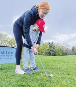  ?? ?? Rosie Allen guides Caitlyn Sheehan as part of training in the First Tee Spring program.