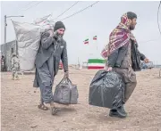  ?? NYT ?? Afghans returning from Iran at the Islam Qala border crossing in March. The foreign ministry of Afghanista­n is investigat­ing claims that dozens of Afghan migrants detained in Iran were thrown into a river.