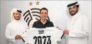  ??  ?? Xavi Hernandez with Al Sadd club officials after signing a new two-season contract as coach.